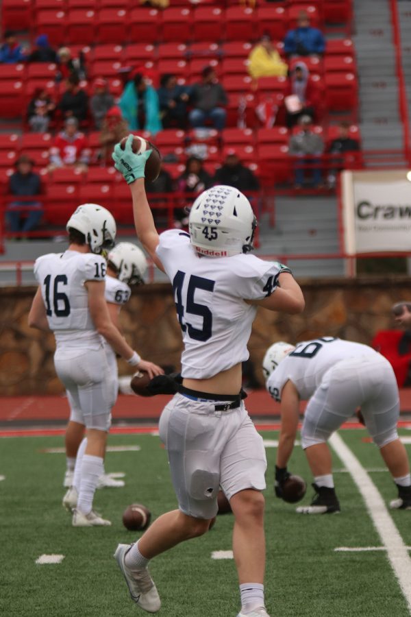 Sophomore Kye Jegen catches the ball during warm ups.  