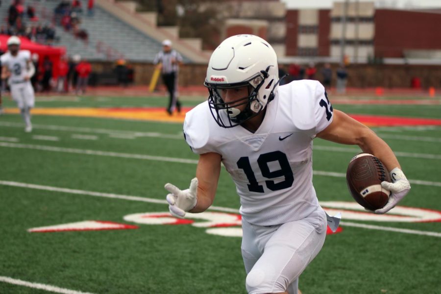 Senior Hayes Miller runs down the field with the ball. 