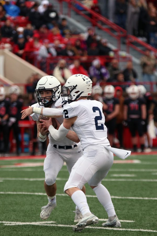Senior Hayden Jay hands off the ball to junior Tristan Baker. 