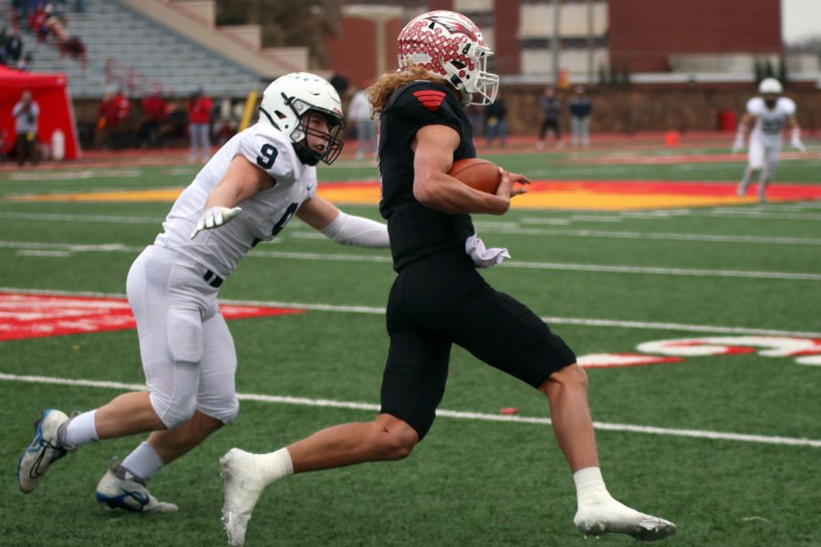 Senior Noah Coy tries to tackle the quarterback, Avery Johnson.