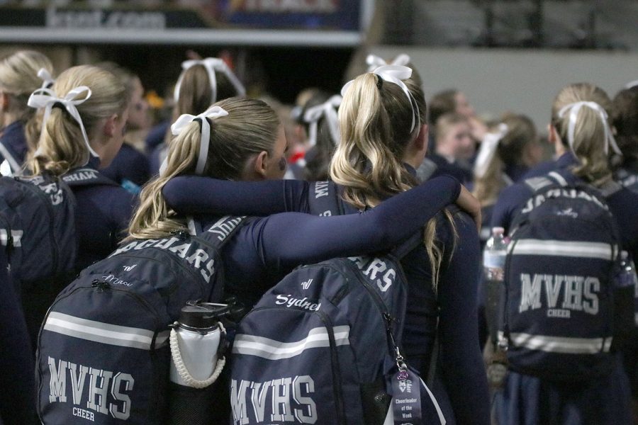 After finding out they did not make finals, junior Maci Burger and freshman Sydney Epperson support each other as they exit the floor.