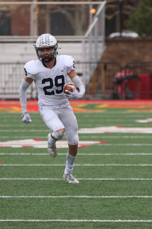 Senior Dylan Massey runs down the field after catching the ball. 