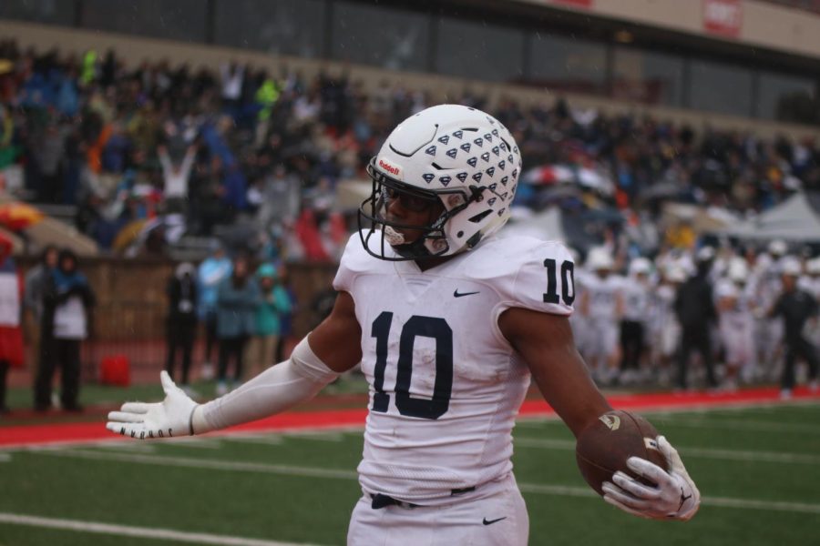 Junior Davion Harris holds his hands out after getting a touchdown. 