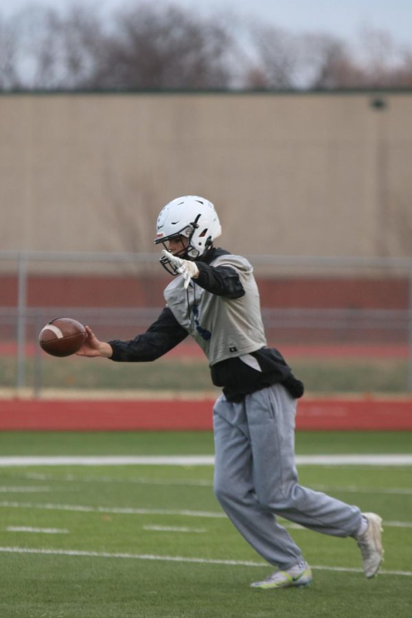 An offensive player punts the football during practice Thursday, Nov. 17.  