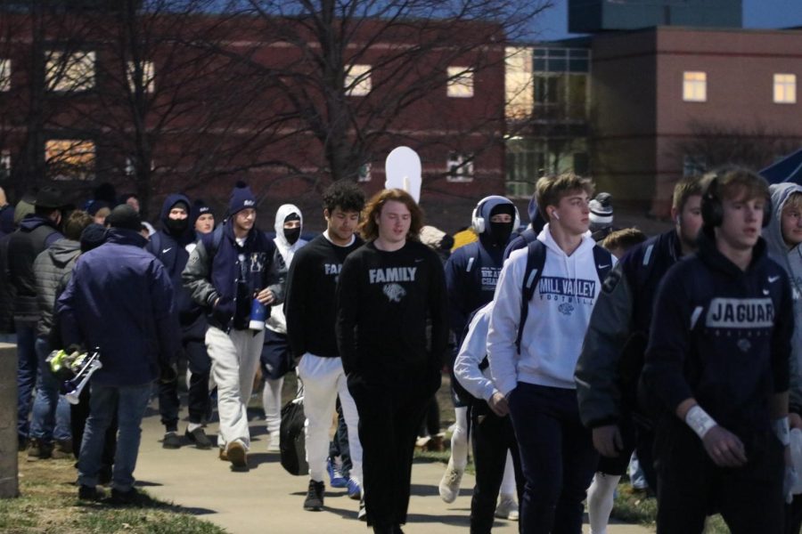 Completing their Jag Walk, football players make their way to the field to suit up for the nights sub-state game against Blue Valley Southwest.