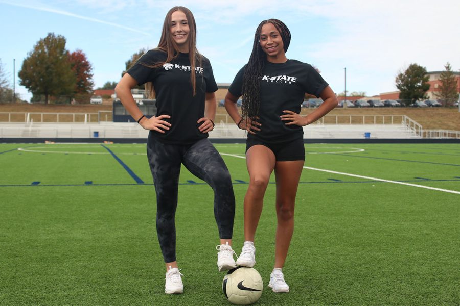 Seniors Laney Reishus and Acacia Weis pose in their matching K-State soccer commits t-shirts on the soccer field, Friday, Oct. 14. Weis and Reishus have formed a friendship through playing competitive soccer that started at age 12.