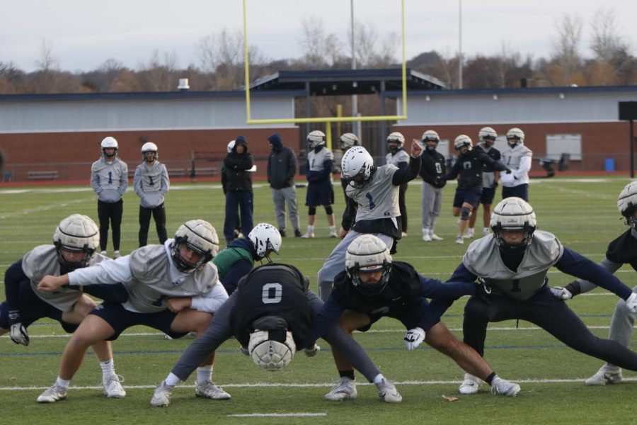 Once the ball is snapped, offensive lineman lean towards the center as kicker Kenton Laughman attempts to kick a field goal.