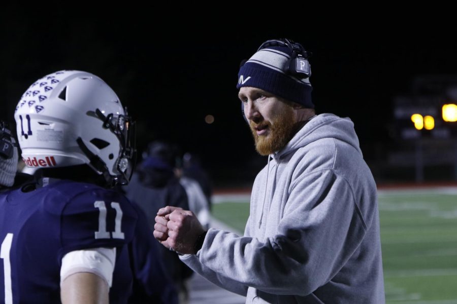 Explaining a play to senior Mark Bauer, coach Andrew Hudgins talks through what he wants.