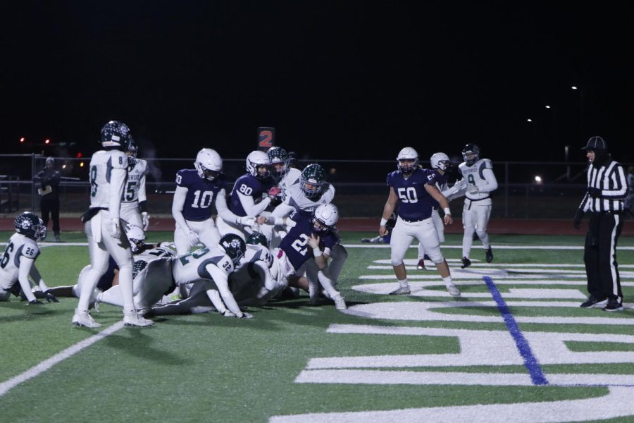 Diving across the goal line, junior Tristan Baker gets in for a touchdown.