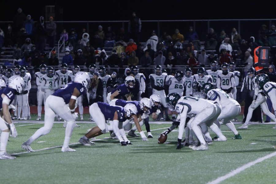 Lined up for a play, the defensive line prepares to go after the quarterback.