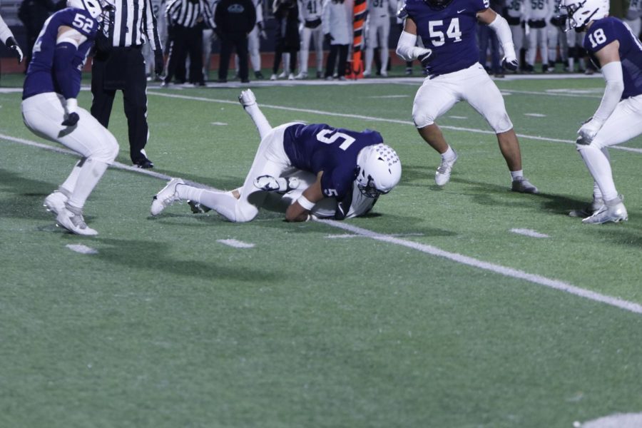 Tackling the opposing quarter back, sophomore Jayden Woods ends the run.
