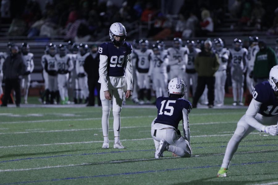 Lining up for a PAT, junior Kenten Laughman looks at his placeholder junior Daniel Blane.