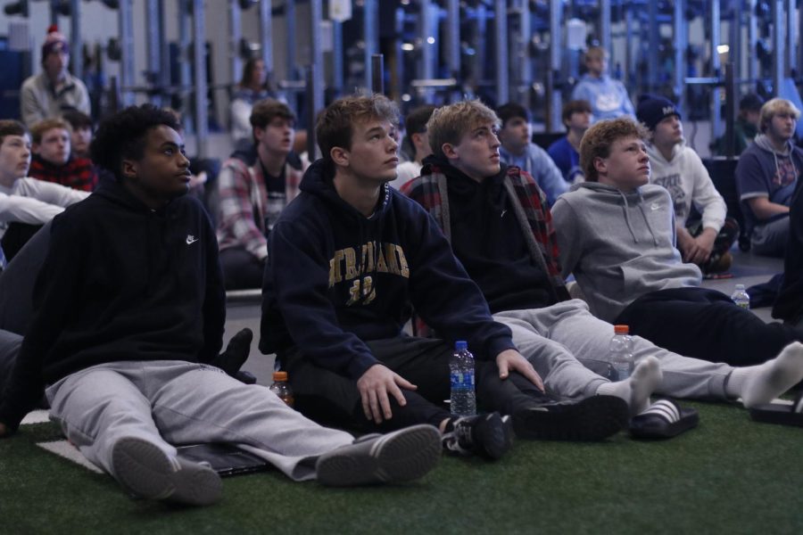 Looking up at the film screen, seniors Baruch Hasabu, Hayes Miller, Hayden Jay and junior Garrett Cronin review a video of a punt return.