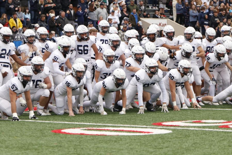 Crawling onto the field, the team does their pregame hype ritual.