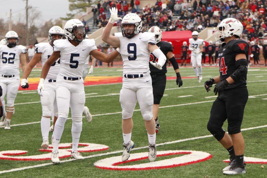 Raising the notorious landshark celebration, senior Noah Coy celebrates a tackle. 