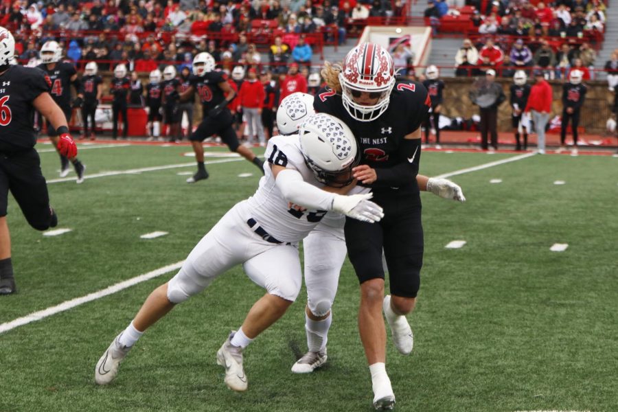 Putting pressure on the quarterback, senior Broc Worcester goes for a sack.