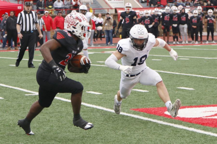 Leaning in to make a tackle, senior Broc Worcester gets ready to dive at the opponents legs.