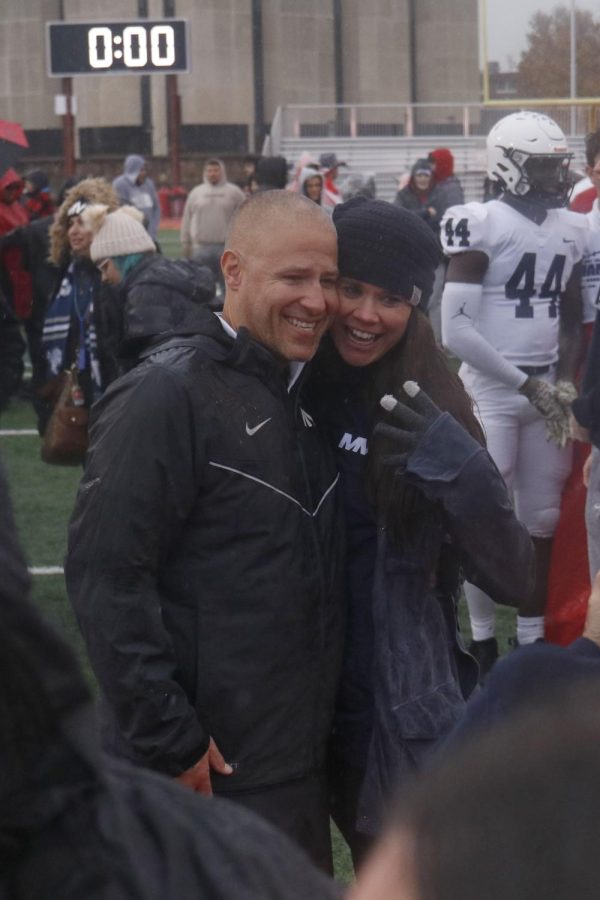 Coach Joel Applebee poses for a picture with his wife.