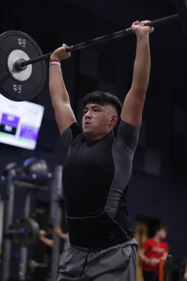 Snatching 135 pounds, junior Julian Meneses completes his lift