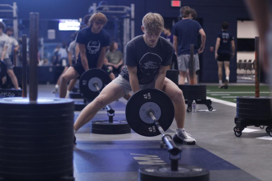 Focusing on his side lunges, junior Bryant Wiltse completes a set during gameday Zero Hour Friday, Nov. 18.