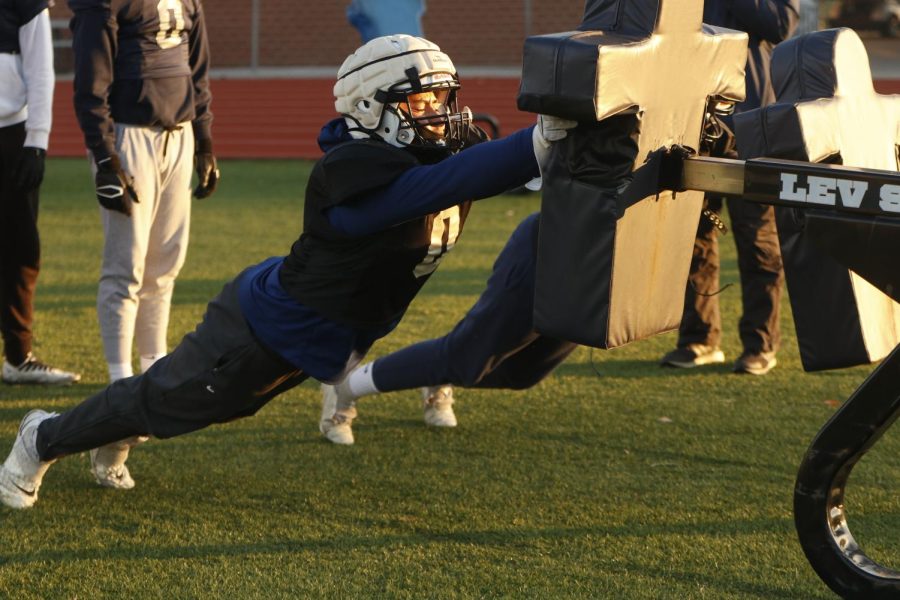 Pushing into the sled, defensive lineman Spencer Vaka works on his form during a drill Wednesday, Nov. 16.