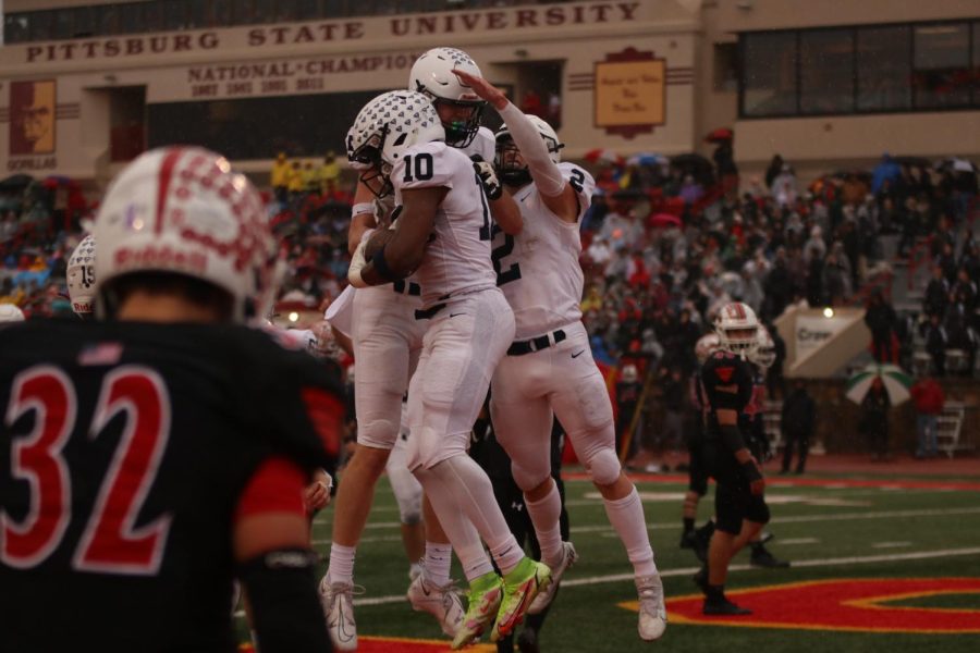 Junior Davion Harris, junior Mason Kemp and senior Hayden Jay celebrate after a touchdown.