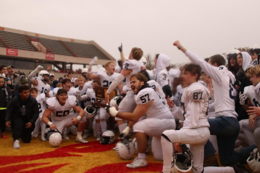 The team receives the trophy and celebrates.