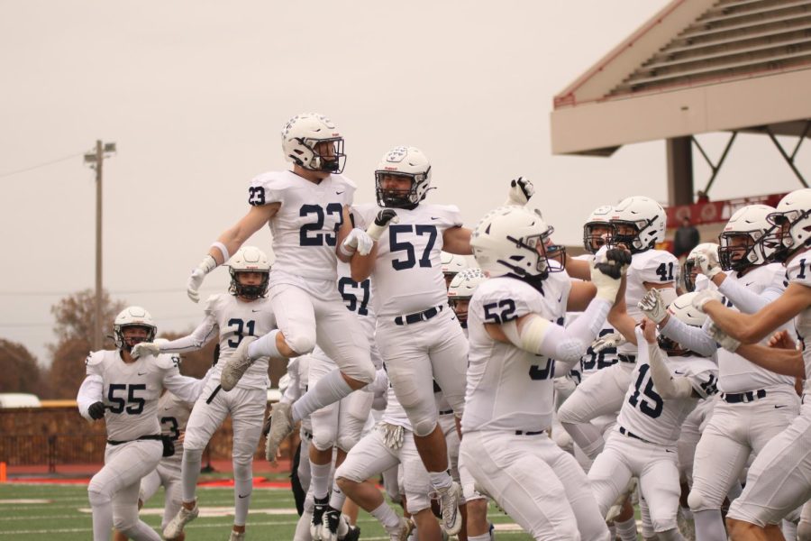 Senior Holden Zigmant and senior Keegan Gracy jump after the toss to begin the game.