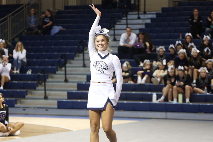 Sophomore Emersyn Jones waves to the crowd as she prepares to do her jumps.