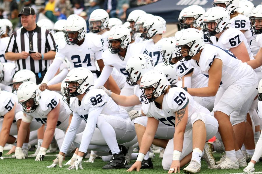 The team awaits the results of the coin toss at the start of the game.