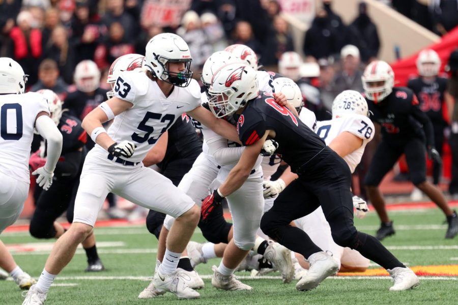 Junior Mason Kemp assists in a tackle against Maize.