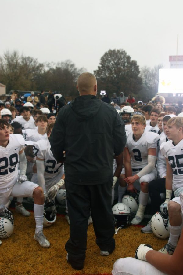 Head coach Joel Applebee gathers the team for a final huddle after their state win. 