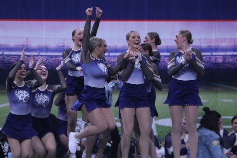 Jumping in the air, junior Trinity Baker celebrates with her team. 
