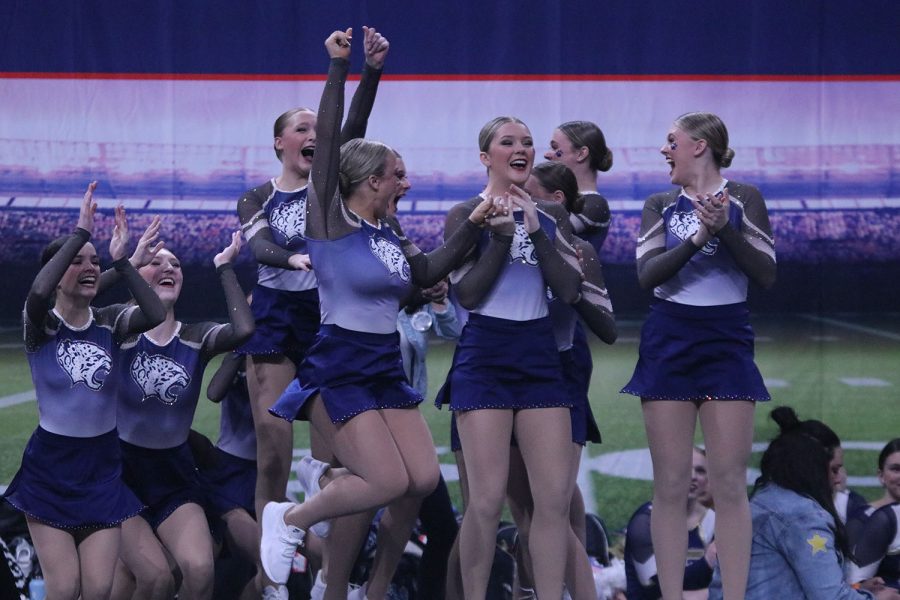 Jumping in the air, junior Trinity Baker celebrates with her team. 
