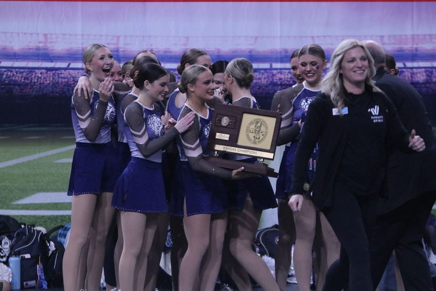 With a smile on her face, junior Trinity Baker accepts the 6A state champions plaque.
