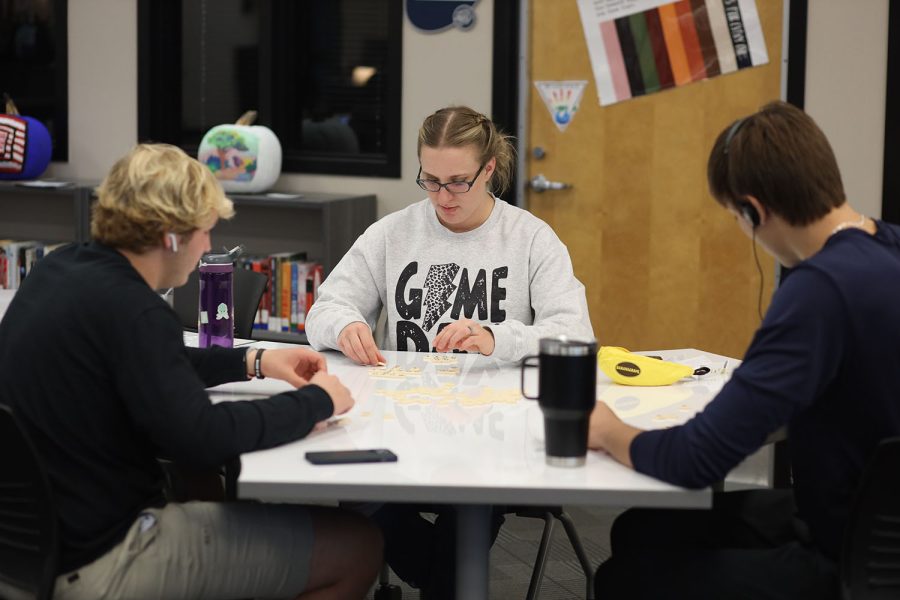 Moving tiles around, English teacher Page Anderson and seniors Ty Marsh and Marko Skavo, play a game during seminar time.