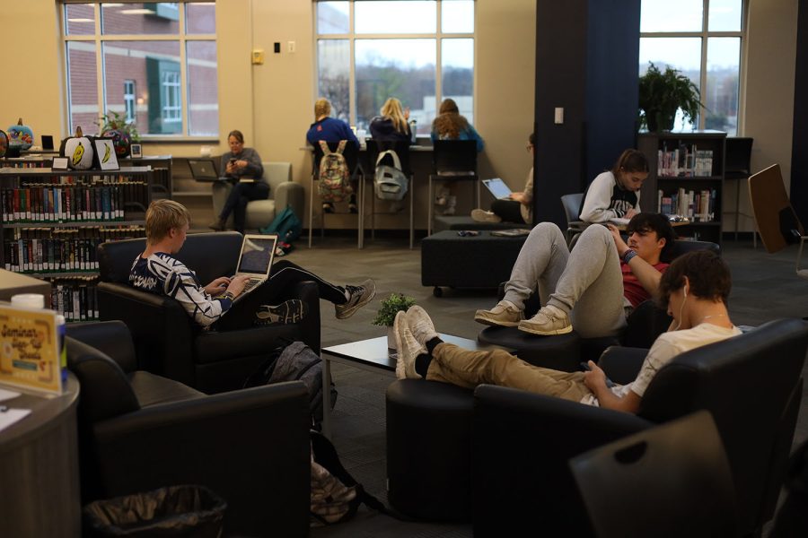 Sitting in the chairs, a group of students take some time to relax during seminar. 