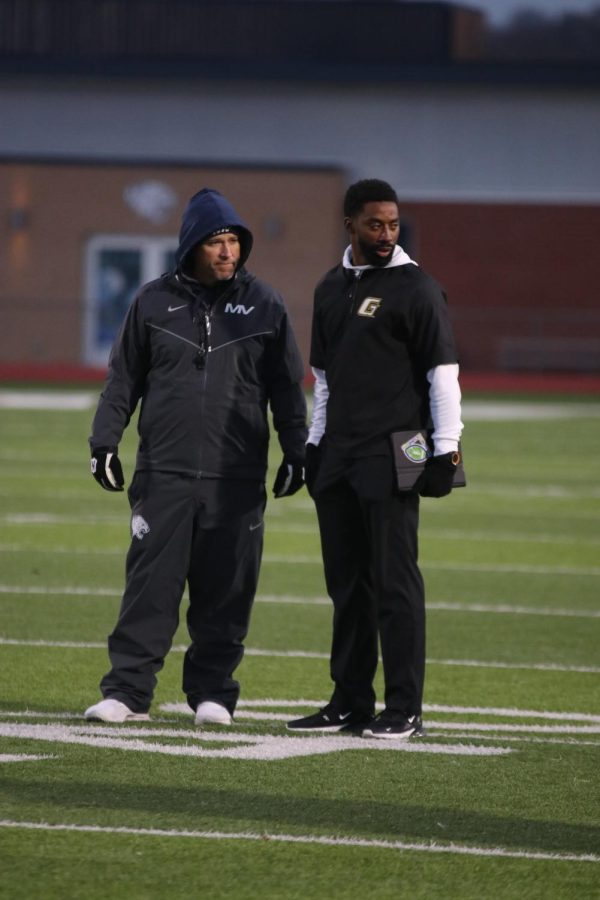 Coach Joel Applebee talks to another coach during Tuesday, Nov. 15 practice. 