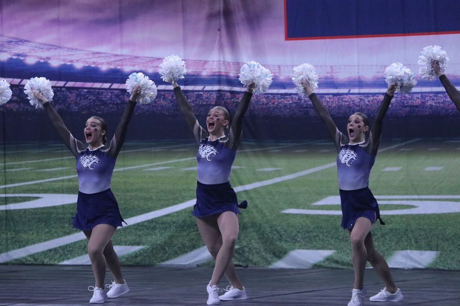 Moving together, sophomore Josie Mason, junior Halle Wampler and freshman Savannah Seymour perform their fight song routine. 
