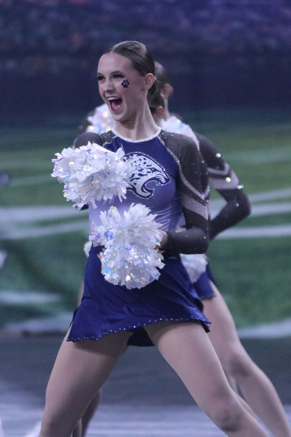 Poms in hand, junior Alli Gervais performs in the Silver Stars’ finals routine. 

