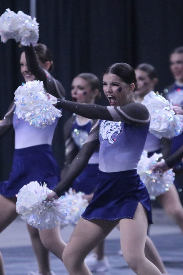 At the front of the group, junior Keira Bret performs with big facial expressions for the crowd. 
