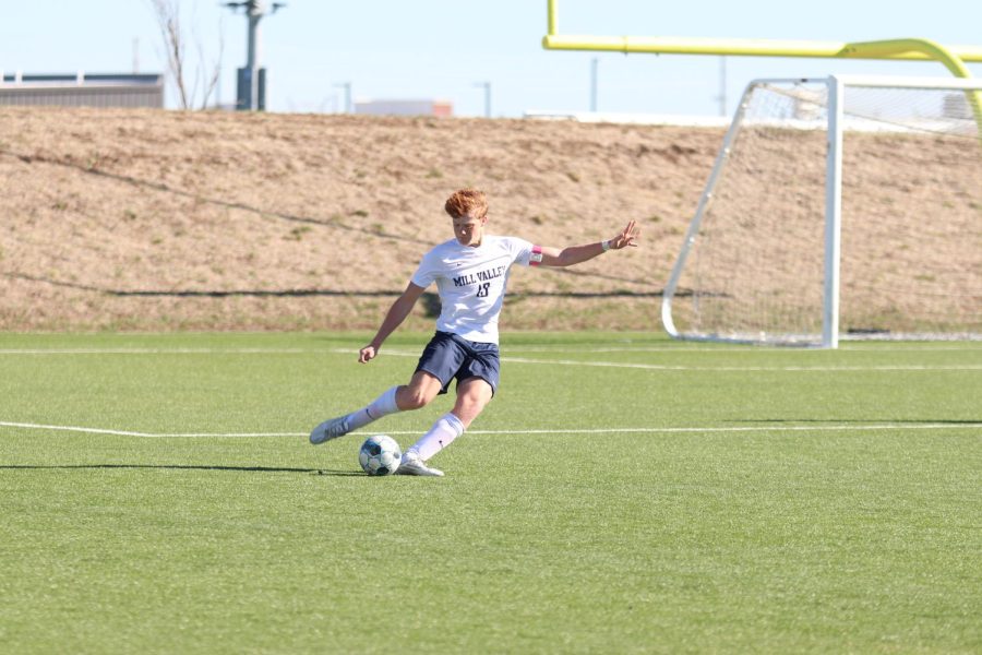 Right out of the box, senior Owen Peachee kicks the ball down the field. 