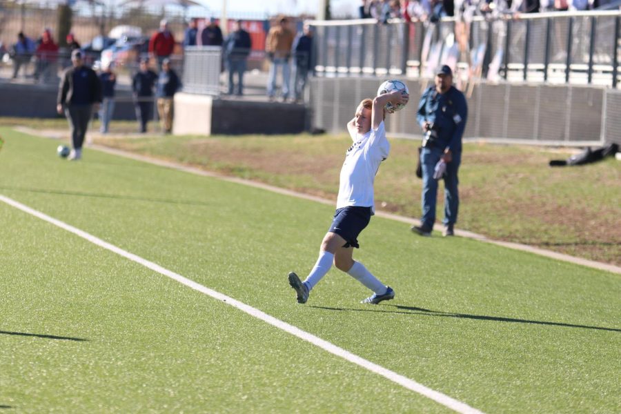 From the sidelines, senior Matt Morgan throws the ball back into the game.