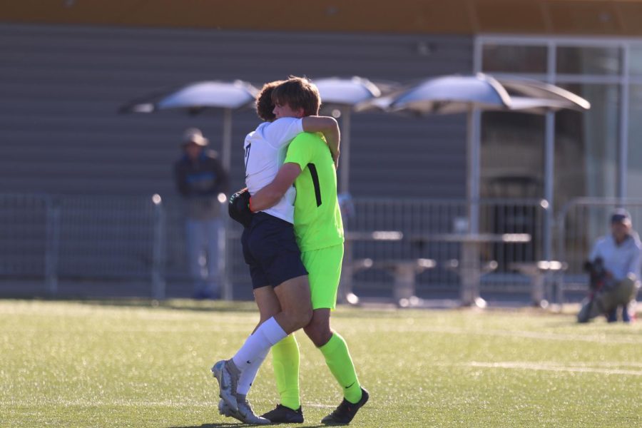 Hugging, seniors Colin Riley and Luke Shideler celebrate the win.