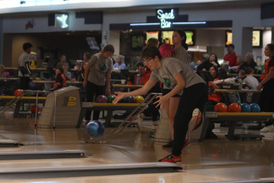 Focused on his form, junior Andre Arnold watches the ball roll out of his hands. 
