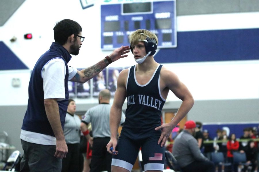 Freshman Chance Zigmant gets pep-talk from the coach during his match.