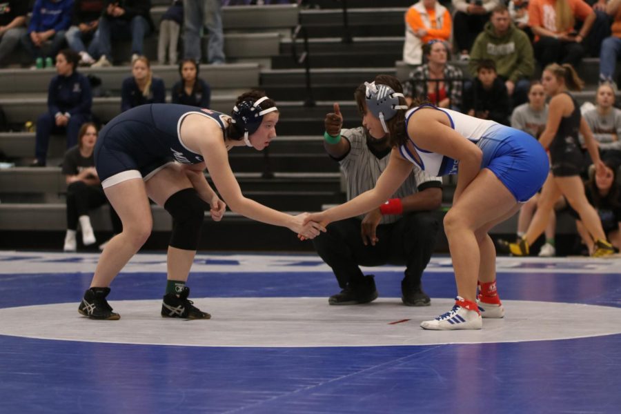 Shaking hands, sophomore Cadence Kerr prepares to wrestle.