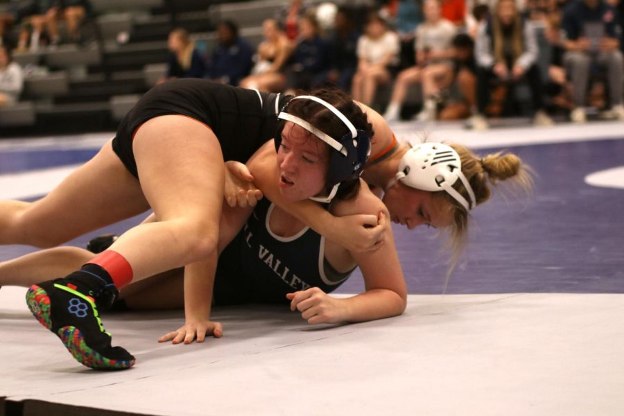 On the mat, sophomore Cadence Kerr attempts to stand up.