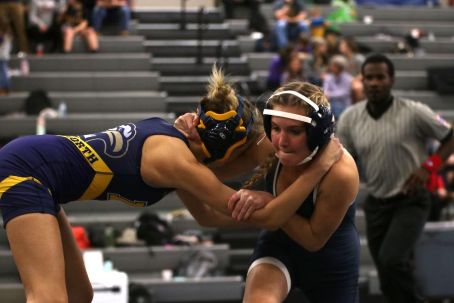 Junior Emily Summa makes an attempt to take her opponent to the mat.