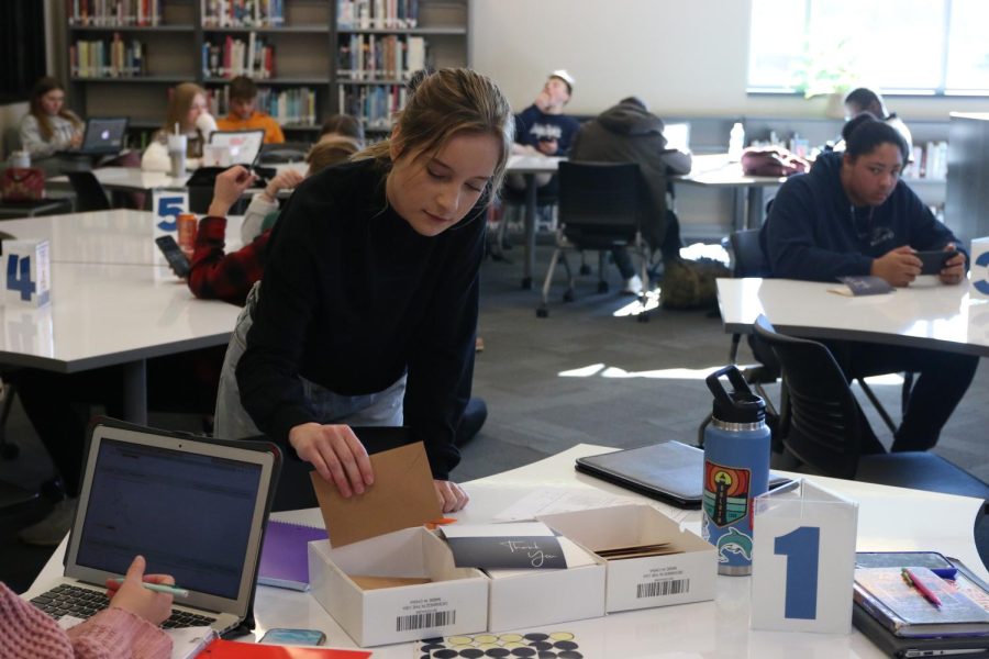 Grabbing an envelope, senior Magen LeBarge prepares to write a thank-you letter to her mock-interviewer.